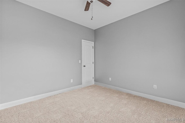 empty room with carpet, baseboards, and ceiling fan