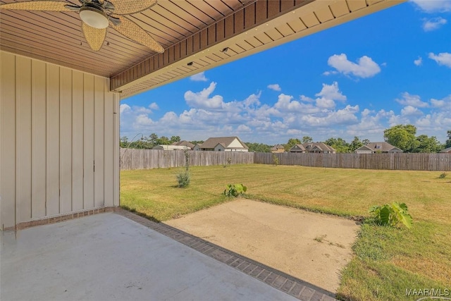 view of yard with a patio, a fenced backyard, and a ceiling fan