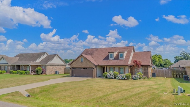 view of front facade featuring a garage, driveway, fence, central AC, and a front yard