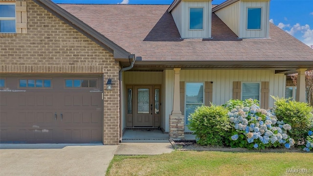 doorway to property with brick siding, roof with shingles, and an attached garage