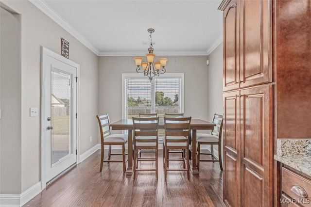 dining space featuring a notable chandelier, ornamental molding, dark wood finished floors, and baseboards