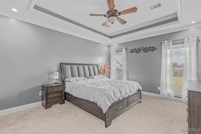 carpeted bedroom with ornamental molding, a raised ceiling, visible vents, and baseboards