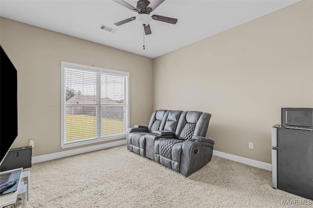 living area with carpet, visible vents, ceiling fan, and baseboards