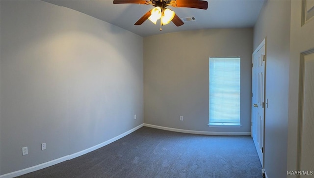 spare room with ceiling fan, carpet floors, visible vents, and baseboards