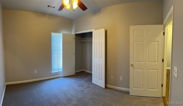 unfurnished bedroom with a closet, carpet, visible vents, and baseboards