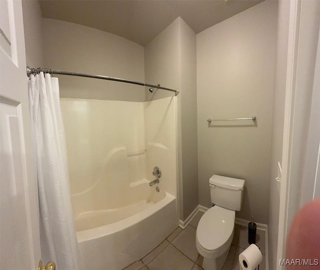 full bathroom with tile patterned flooring, baseboards, shower / tub combo with curtain, and toilet