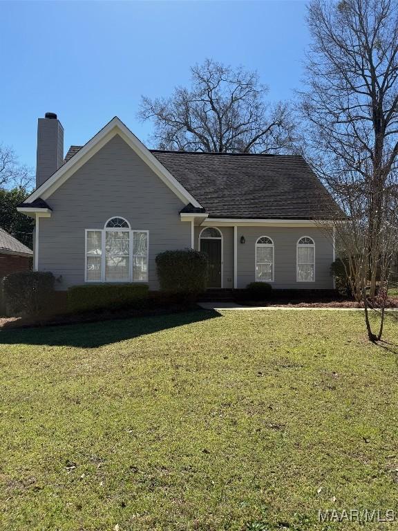 view of front of property with a front lawn and a chimney