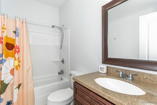 full bath featuring toilet, shower / bath combo with shower curtain, and vanity