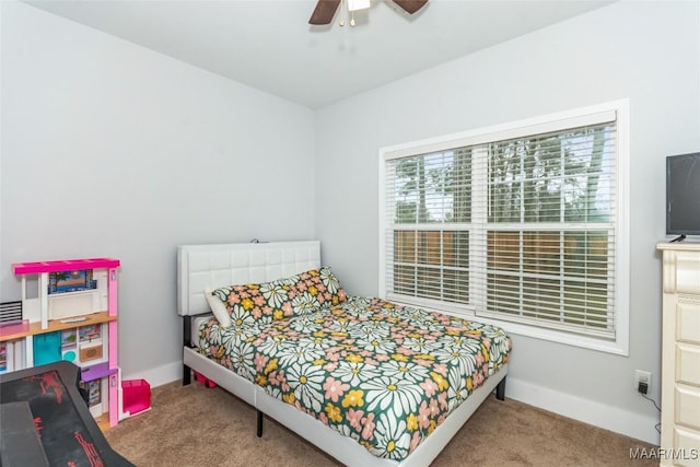 bedroom with a ceiling fan, baseboards, and carpet flooring