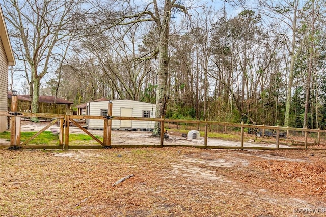 view of yard featuring fence and a gate