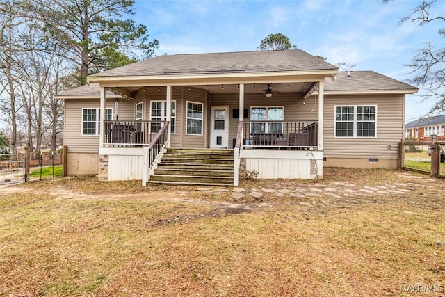 view of front of property featuring a front yard, crawl space, ceiling fan, and fence