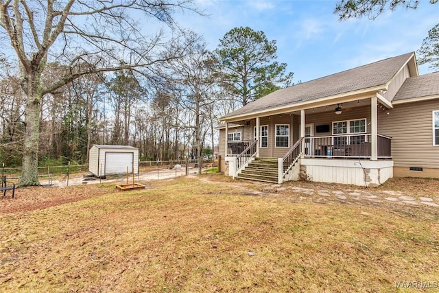 view of front of home featuring ceiling fan, an outdoor structure, fence, stairs, and crawl space