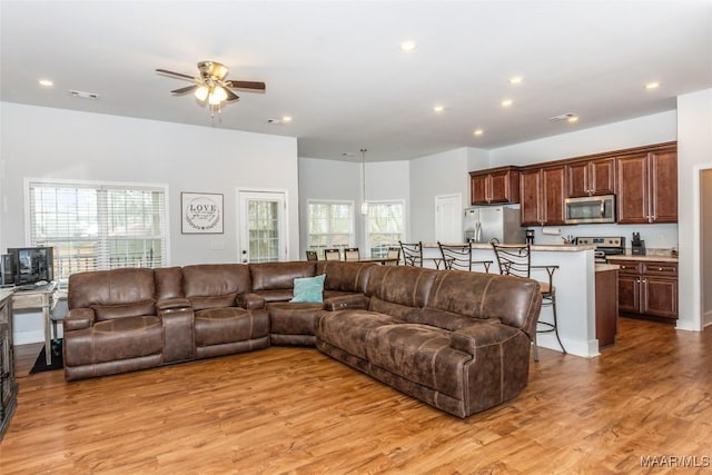 living area with light wood-style floors, visible vents, a ceiling fan, and recessed lighting