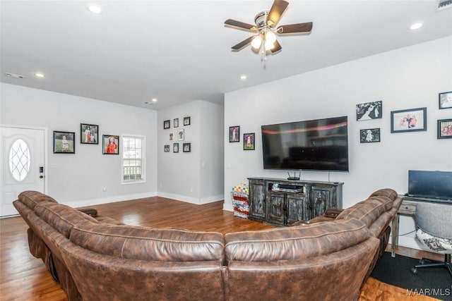 living room featuring ceiling fan, baseboards, wood finished floors, and recessed lighting