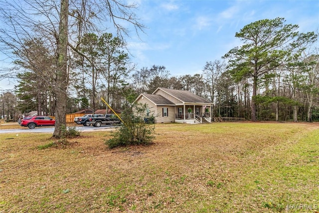exterior space with covered porch and a front yard