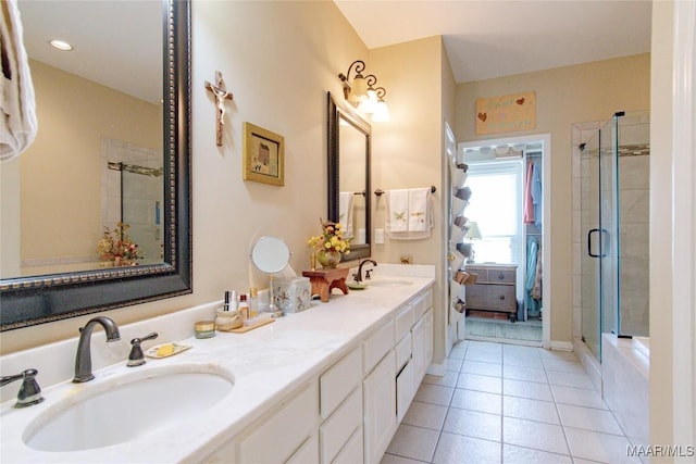 bathroom featuring a stall shower, a sink, and tile patterned floors