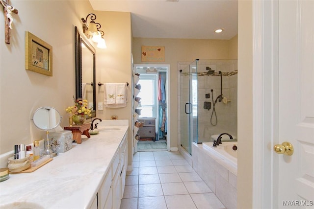 bathroom featuring a stall shower, tile patterned flooring, vanity, and a bath