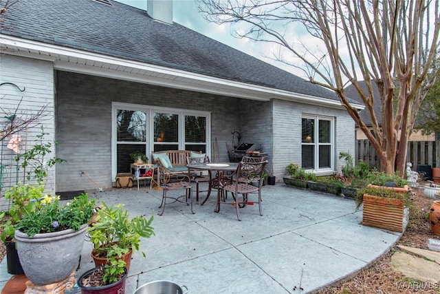 view of patio featuring fence and outdoor dining space