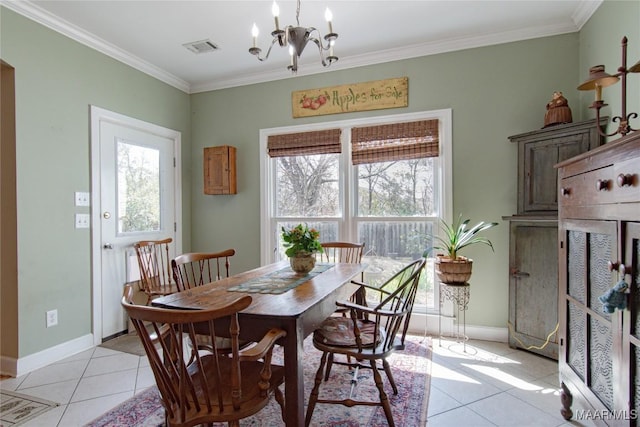 dining area featuring light tile patterned floors, ornamental molding, a chandelier, and baseboards