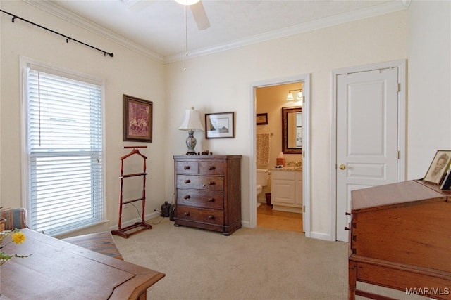 bedroom featuring light colored carpet, crown molding, baseboards, and ensuite bathroom