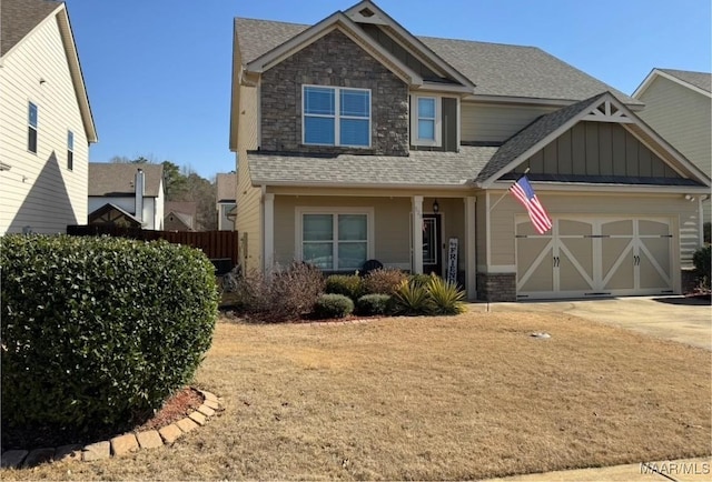 craftsman inspired home featuring board and batten siding, roof with shingles, driveway, and an attached garage