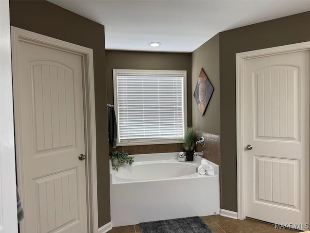 bathroom featuring a garden tub and tile patterned floors