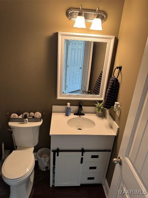 bathroom with toilet and vanity