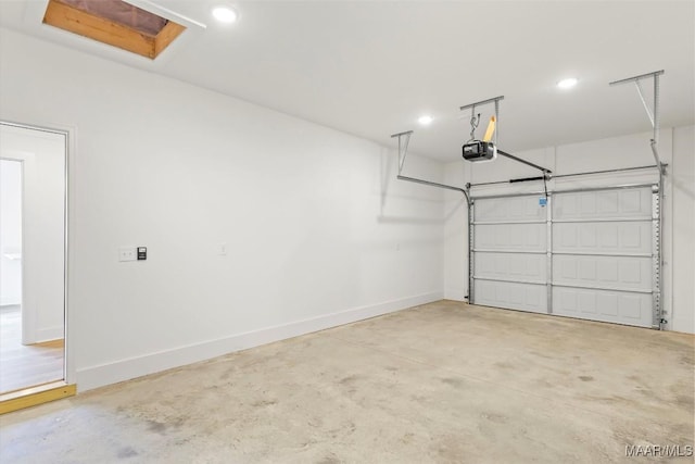 garage with a garage door opener and baseboards