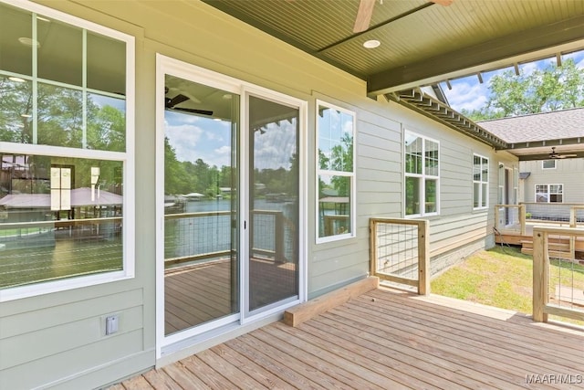 deck featuring a water view and ceiling fan