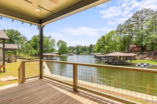 view of dock with a yard and a water view