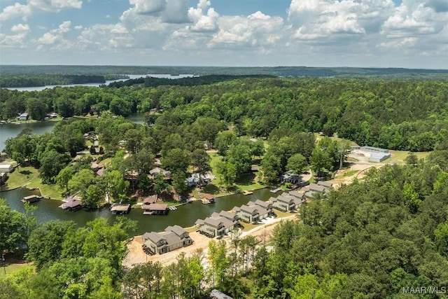 drone / aerial view featuring a residential view, a water view, and a forest view