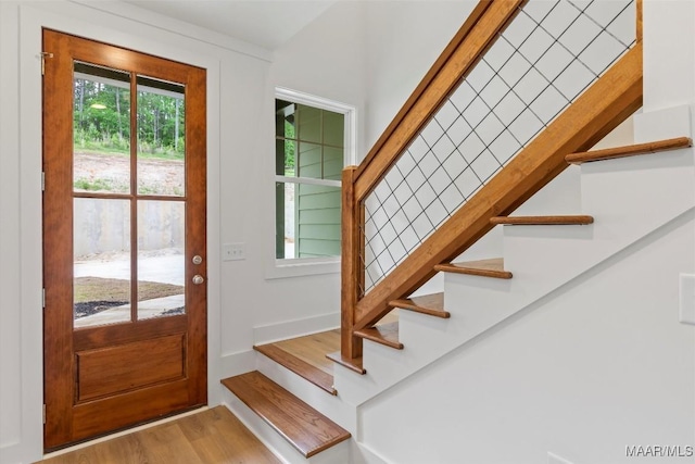 entrance foyer with light wood-type flooring and stairway