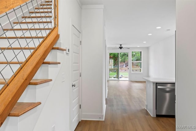 stairway with baseboards, ceiling fan, wood finished floors, and recessed lighting