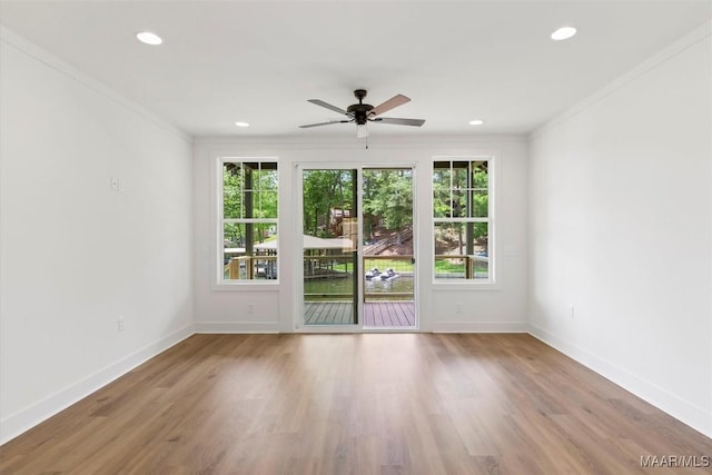 spare room featuring recessed lighting, baseboards, and wood finished floors