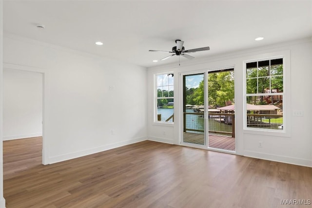 empty room featuring recessed lighting, baseboards, and wood finished floors