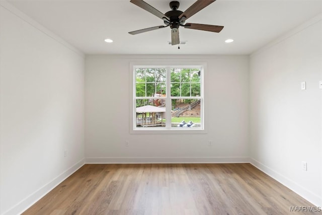 spare room with recessed lighting, light wood finished floors, and baseboards