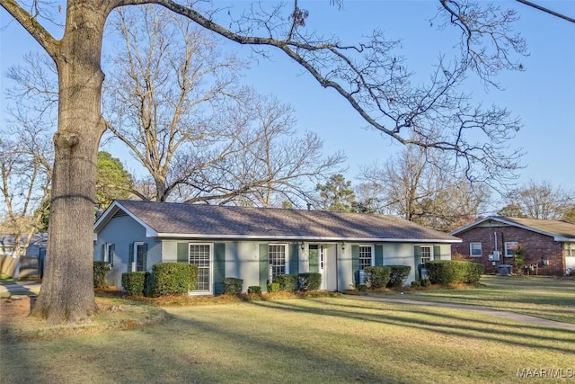 ranch-style house with a front lawn and stucco siding