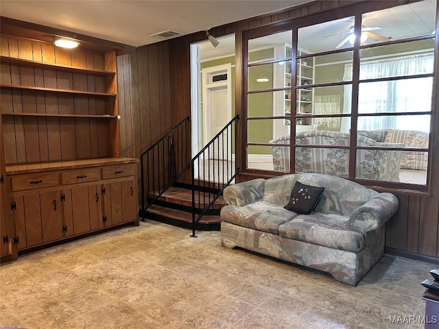 911 W Tuskeena St, Wetumpka, AL 36092 - living room with ceiling fan, built in features, wood walls, and visible vents