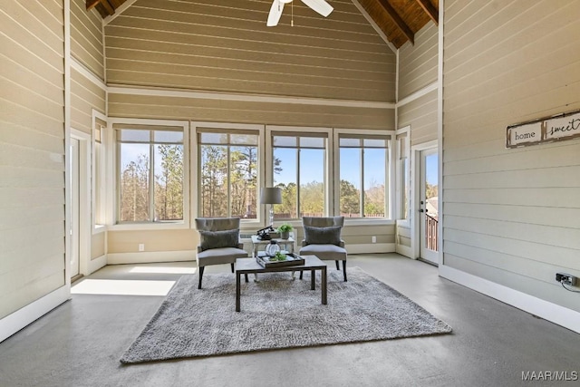 sunroom / solarium featuring vaulted ceiling, ceiling fan, and wood ceiling