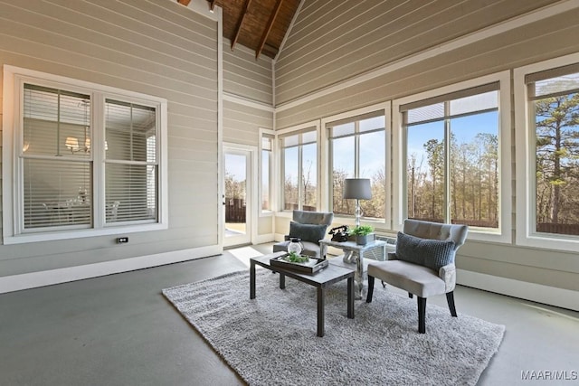 sunroom with lofted ceiling, wooden ceiling, and plenty of natural light