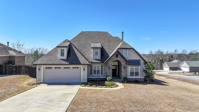 view of front facade with stone siding, concrete driveway, roof with shingles, and fence