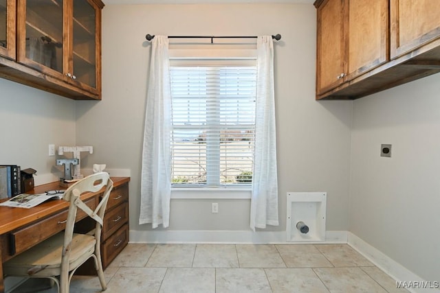 home office with baseboards and light tile patterned floors