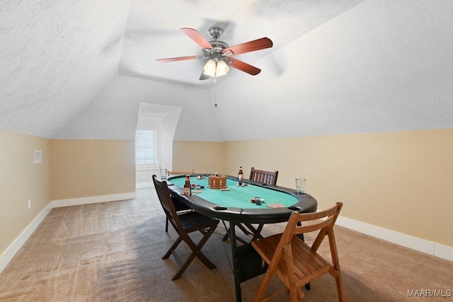 playroom featuring carpet floors, baseboards, a textured ceiling, and lofted ceiling