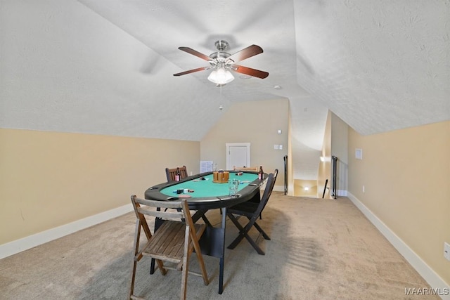 game room with light colored carpet, a textured ceiling, and baseboards