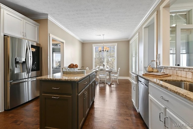 kitchen featuring stainless steel appliances, dark wood-style flooring, and crown molding