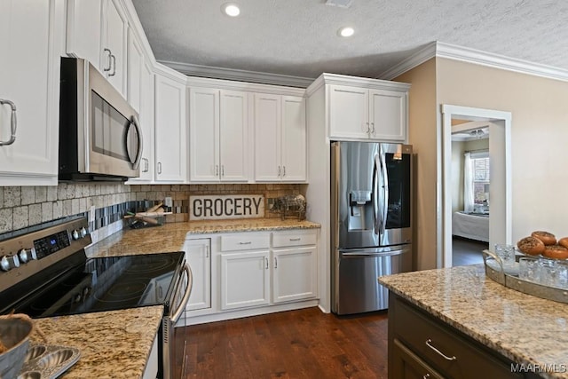 kitchen featuring stainless steel appliances, white cabinetry, dark wood-style floors, tasteful backsplash, and crown molding