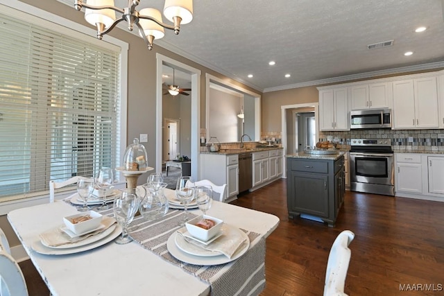 kitchen featuring dark wood-style floors, visible vents, backsplash, appliances with stainless steel finishes, and white cabinetry