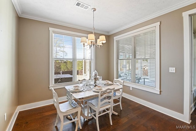 dining area with dark wood-style flooring, crown molding, a notable chandelier, visible vents, and baseboards