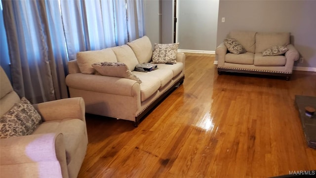 living room featuring baseboards and wood finished floors