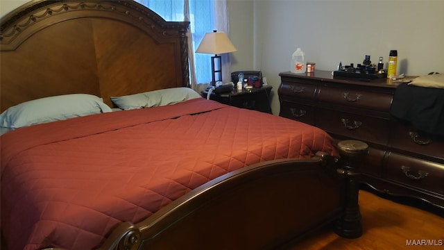 bedroom featuring wood finished floors